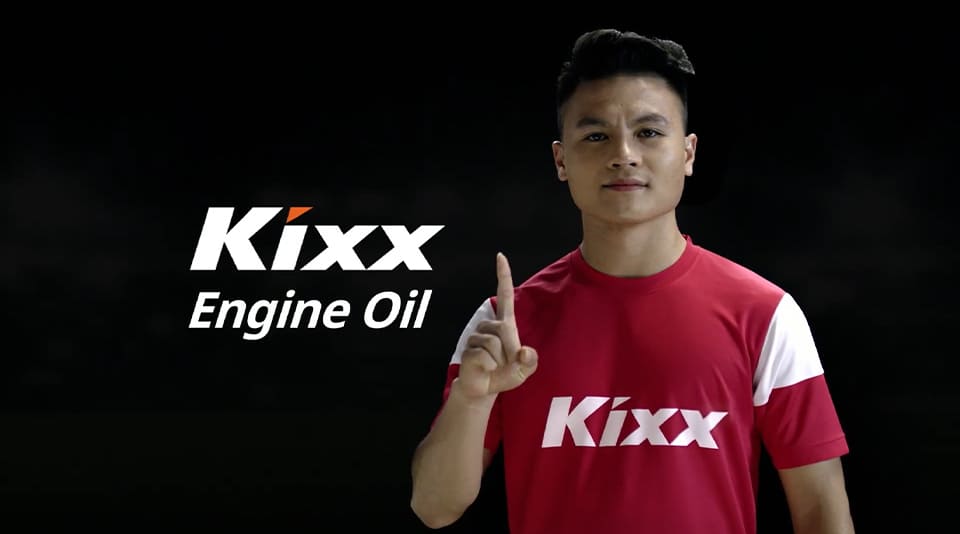 Kixx brand ambassador Nguyen Quang Hai stands against a black background wearing a red and white Kixx football shirt.