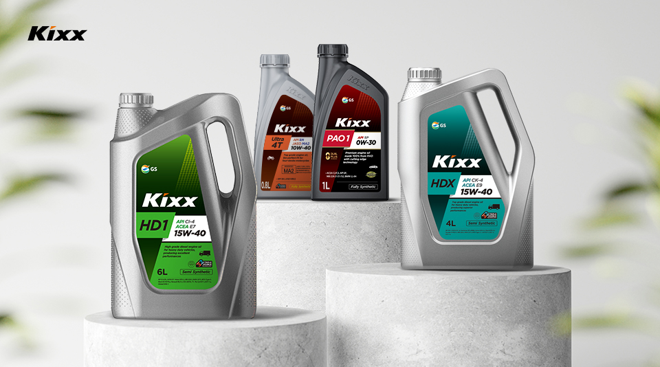 Four varying Kixx container designs lined up on a grey surface against a bright white backdrop.
