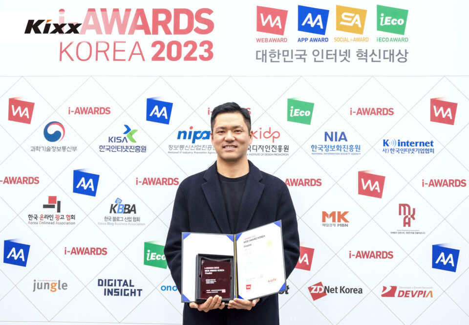 A photo of a person holding a certificate and smiling brightly