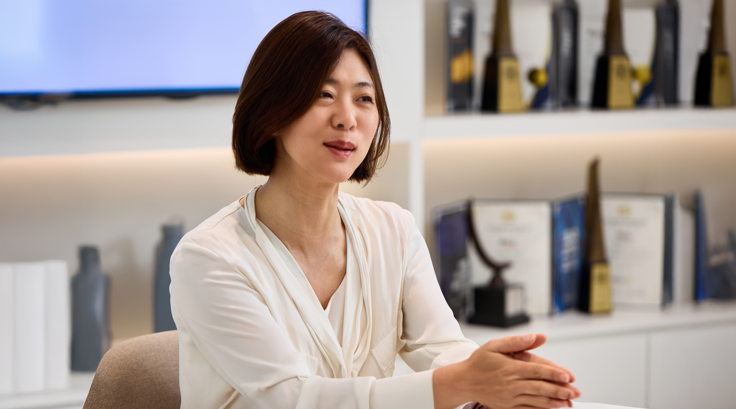 Team Leader Ji Seon Park with trophies in the background 