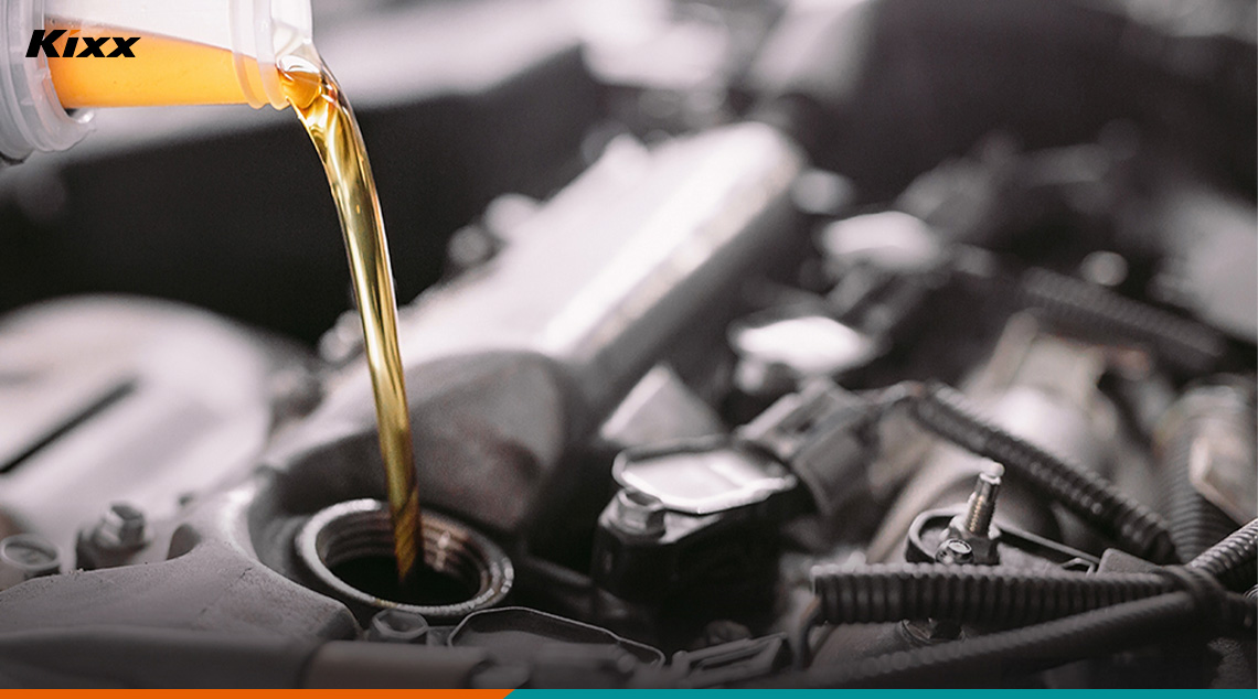 A mechanic pouring Kixx engine oil into vehicle
